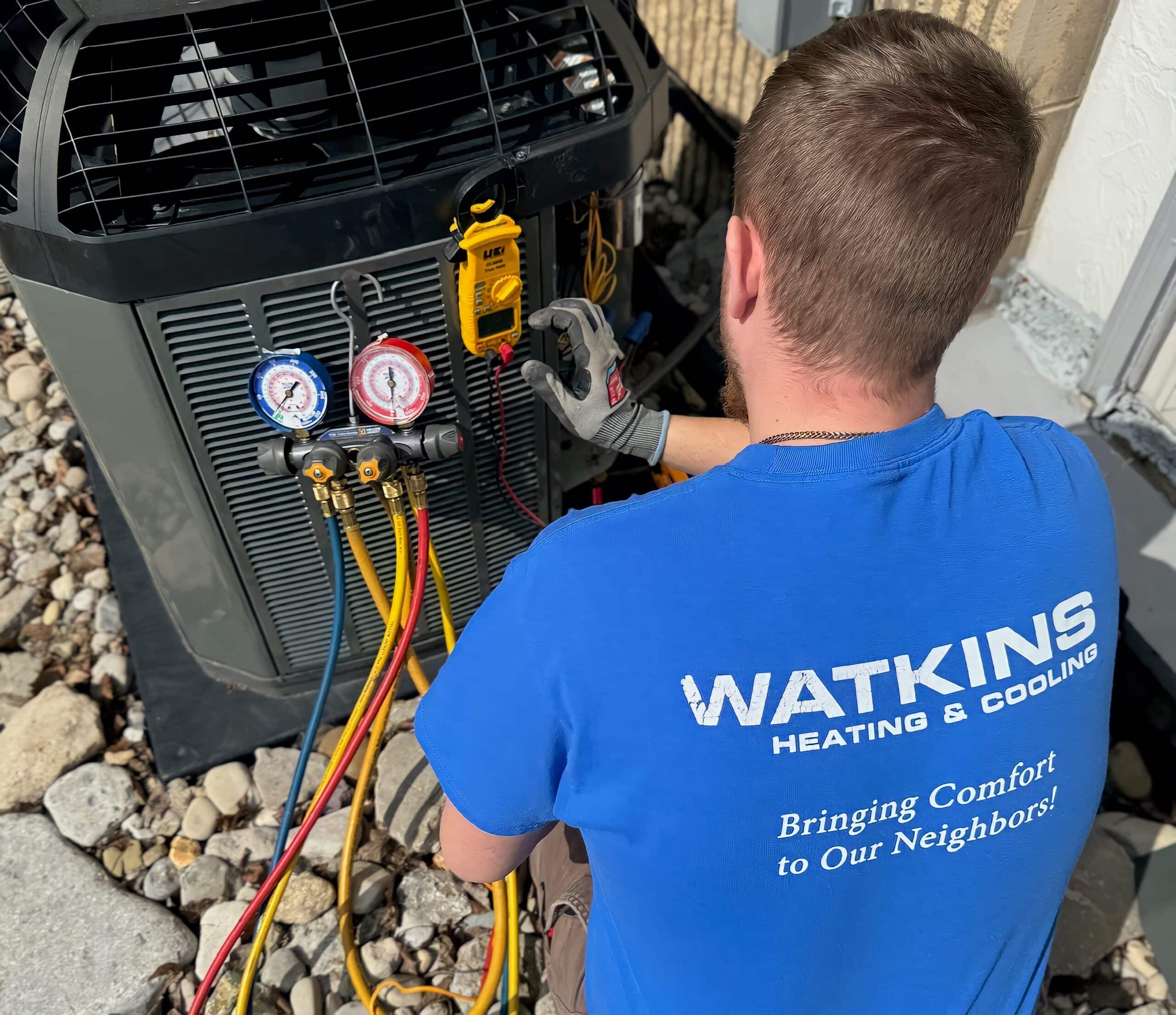 Watkins HVAC technician checking AC refrigerant Freon levels